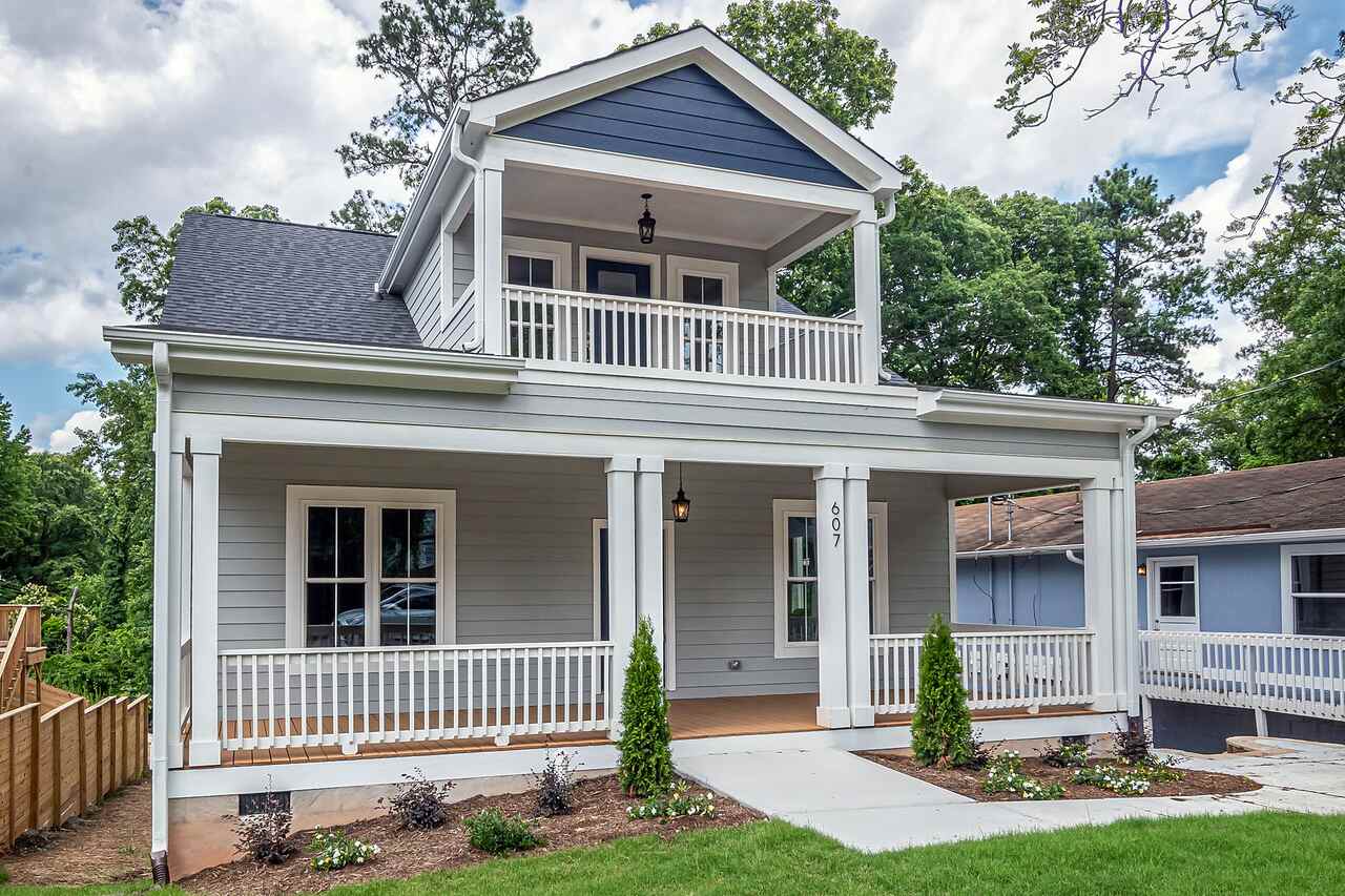 A two-story house with classic detailing and a well-kept front yard