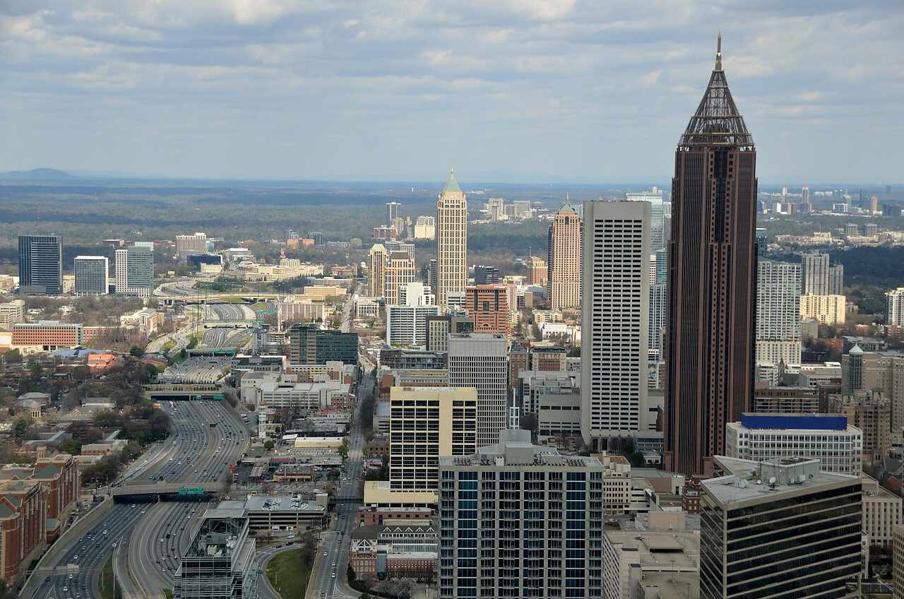 Downtown Atlanta seen from above, with the towers rising out of the tree cover